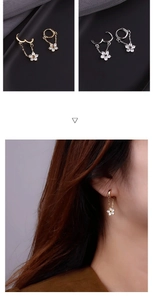 Detail of flower dangle earrings with cubic zirconia and long metal fringe tassels