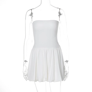 Detailed view of the white strapless mini dress featuring a stylish bubble hem and high waist