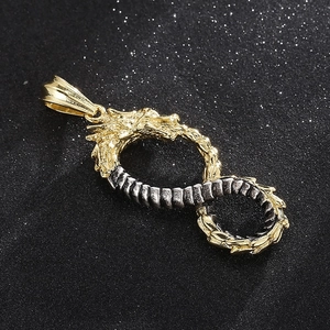 Detailed macro view of dual-tone dragon infinity symbol pendant in gold and steel