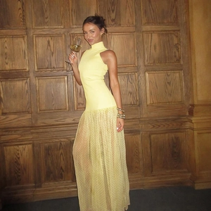 Dettaglio del top in maglia giallo chiaro e gonna in mesh a pois su una modella
