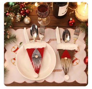 Close-up of Nordic gnome cutlery holders in red and brown on a festive Christmas table