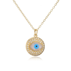 Macro detail of 18K gold evil eye necklace with blue zircon and white shell inlay
