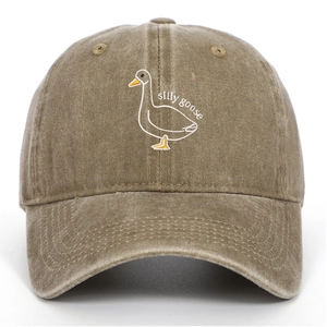 Close-up of silly goose embroidery on washed khaki baseball cap with vintage texture
