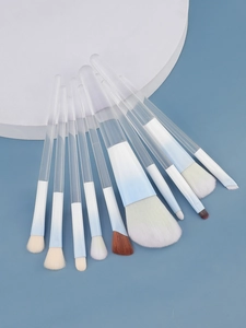 Detailed close-up of 10-piece gradient blue makeup brush set with clear acrylic handles