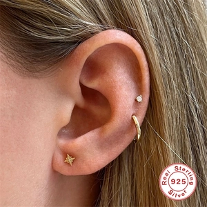 Three-piece set of 925 sterling silver gold-plated star and stud earrings on model