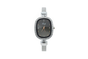 Detailed view of oval quartz watch with crystal bezel and silver mesh band