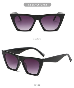 Detail view of black square sunglasses with purple gradient lenses and wide temples