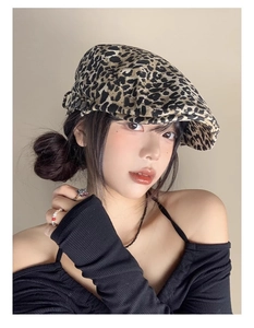 Detail view of the leopard print beret texture on a model with stylish accessories