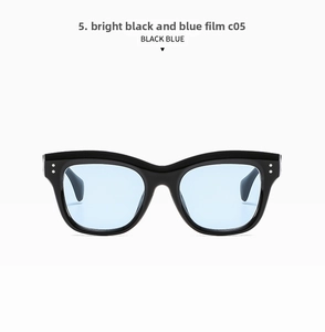 Detail of fashion square cat-eye sunglasses with black frames and light blue lenses