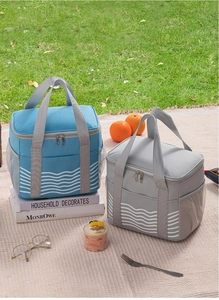 Insulated lunch bags with wave pattern and mesh pockets shown in an outdoor picnic setting