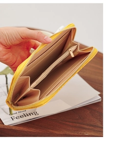 Detailed interior of a yellow long wallet with accordion compartments and card slots