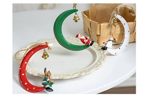 Detailed view of Christmas iron moon ornaments with resin figures and golden bells