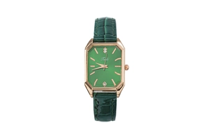 Detail of emerald green dial watch with gold case and green faux leather strap