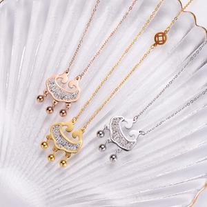 Detail of three stainless steel lock necklaces in gold, rose gold and silver with gems
