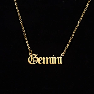 Detail of Gemini zodiac pendant in gothic font on gold stainless steel chain