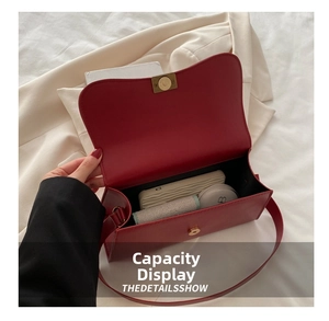 Internal capacity of the red leather underarm bag with power bank and cosmetics