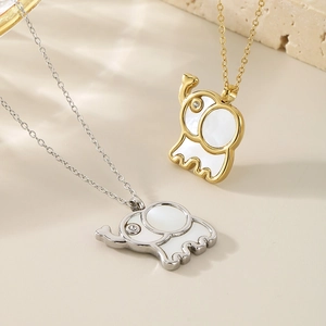 Detail of cute elephant pendant necklaces in gold and silver with inlaid crystal eyes