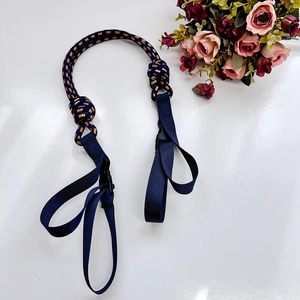 Detail of dark blue nylon strap with gold twill accents and plastic buckle for bags