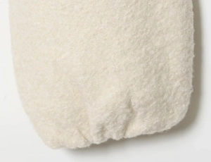 Close-up of cream textured jacket fabric with elastic cuff showing warm fleece detail