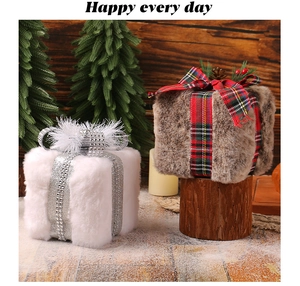 Detail of plush Christmas gift box ornaments with glitter ribbons and pine cone accents