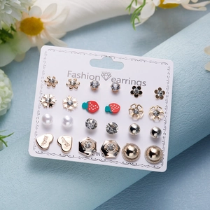 Detailed macro view of 12-pair earring set featuring hearts, stars, and pearls