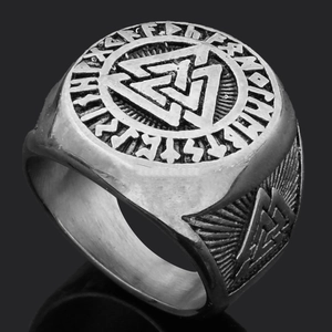 Macro shot of silver Valknut ring with Norse runes on polished stainless steel band