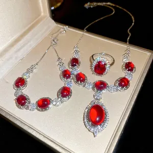 Luxurious silver jewelry set with oval red gemstones and cubic zirconia floral accents