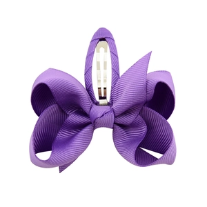 Detail of purple ribbon bow hair clip with a durable silver metal alligator grip