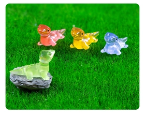 Detailed view of colorful luminous resin lizards on miniature grass landscape