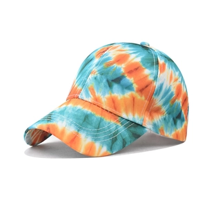 Close-up of the cotton tie-dye baseball cap with orange and blue galaxy pattern detail