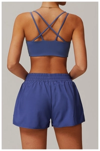 Détail d'un ensemble de yoga bleu roi avec dos à bretelles croisées et short de sport