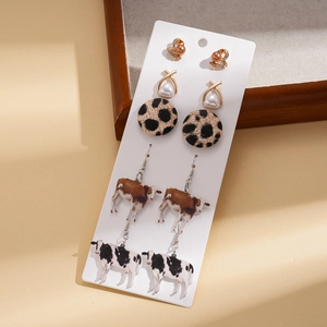 Ten-piece gold earring set with cow print, leopard patterns, and pearl details