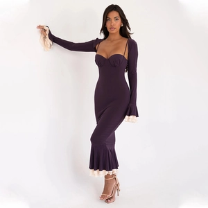 Detailed view of dark purple bodycon dress featuring beige ruffled hem and fishtail design