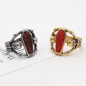 Gothic skull coffin ring in silver and gold metal with red enamel inlay details