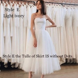 Detail of light ivory wedding dress featuring tiered tulle layers without dot patterns