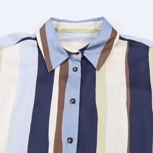 Detailed view of the lapel and vertical multi-colored stripes on a satin-textured shirt