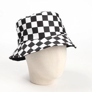 Close-up of the black and white checkerboard pattern on the canvas bucket hat texture