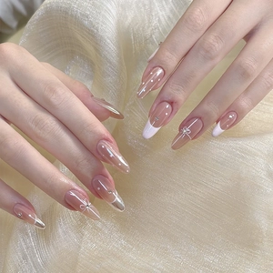 Polka dot nude French press-on nails with white bow and rhinestones on gold background