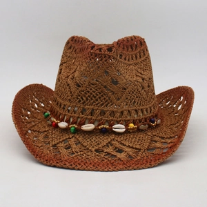Detail of a brown woven straw sun hat featuring colorful beads and natural seashells decoration