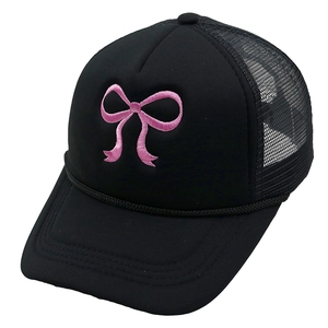 Close-up of pink bow embroidery on a black mesh trucker hat with detailed stitching