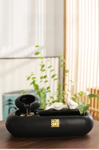 Ceramic indoor fountain with misting system, decorative ducks, and live aquatic plants