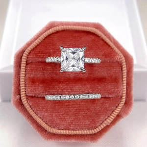 Sparkling princess cut square diamond ring set with four-prong silver band in velvet box