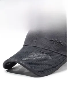 Close-up of breathable camouflage mesh fabric and mountain sport embroidery on gray cap