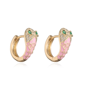 Macro detail of gold-plated snake earrings with pink enamel scales and green zircon eyes