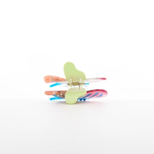 Detail of butterfly claw clip featuring marble pattern wings and sparkling rhinestones