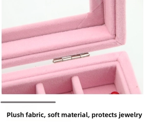 Detail of pink velvet jewelry box interior with soft compartments and metal hinges