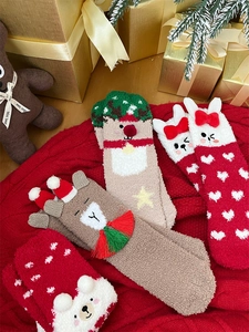Cozy coral fleece Christmas socks featuring reindeer and rabbit designs on red knit background