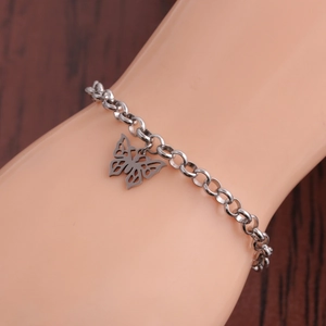 Silver stainless steel butterfly charm bracelet with thick links on female model wrist