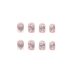 French tip press-on nails with white heart design, rhinestones and pink blush base