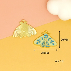 Detail of 28x20mm gold-plated butterfly pendant with white and blue enamel patterns